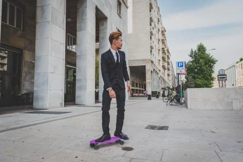 Young handsome Asian model posing with his skateboard Stock Photos