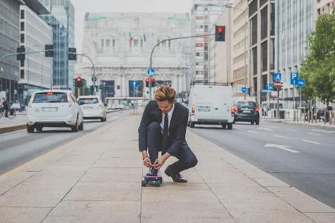Young handsome Asian model posing on his skateboard Stock Photos