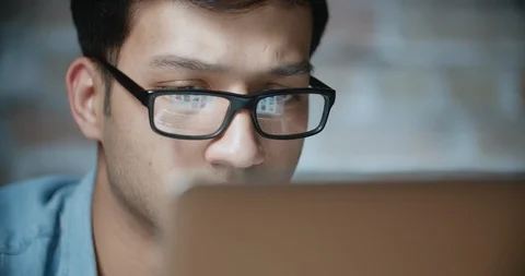 Young handsome asian student working on project at computer dollyshot 4k Stock Footage