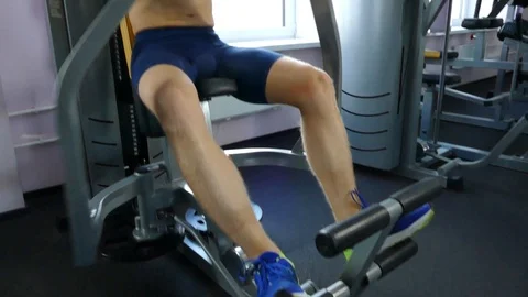 A young handsome athlete is actively engaged in sports exercises in the gym Stock Footage 98083091