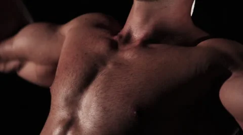 Young handsome athlete does chest and shoulder pumping exercise Stock Footage 62022907