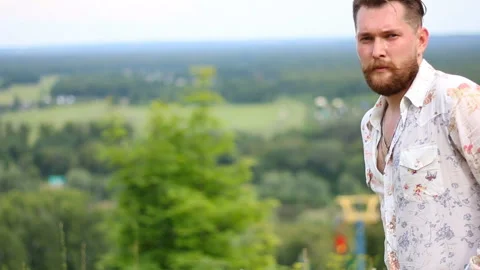 Young handsome attractive bearded model man in nature context. Stock Footage 87663603