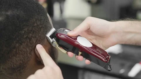 Young handsome bearded african man getting a haircut at the barbershop. Handsome Stock Footage 169192377
