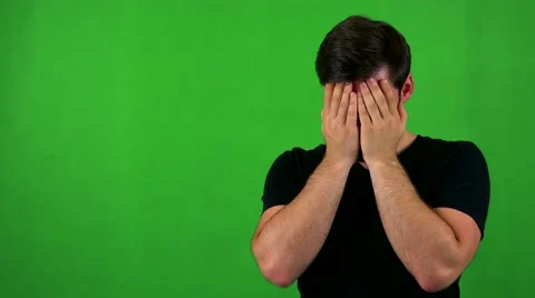 Young handsome bearded man cries - green screen - studio Video stock 67477464