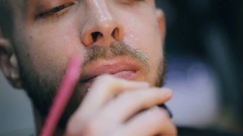 Young handsome bearded man getting a haircut in a modern barber shop. Видео 86477872