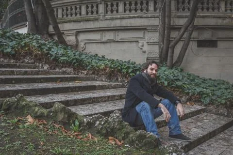 Young handsome bearded man posing in the city streets Stock Photos