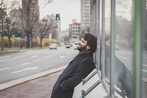 Young handsome bearded man posing in the city streets Stock Photos