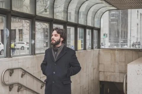 Young handsome bearded man posing in the city streets Stock Photos