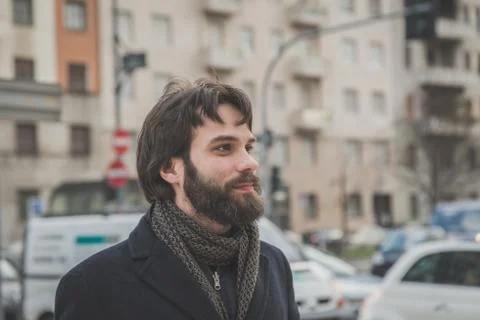 Young handsome bearded man posing in the city streets Stock Photos