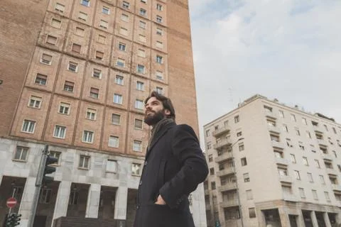 Young handsome bearded man posing in the city streets Stock Photos