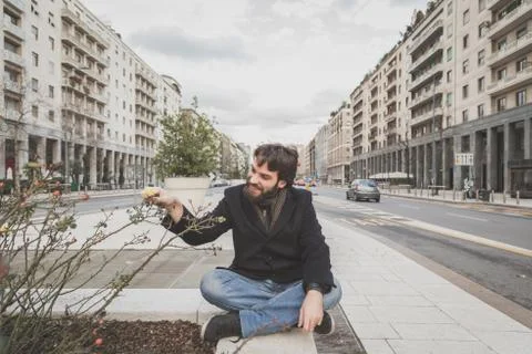 Young handsome bearded man posing in the city streets Stock Photos
