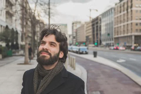 Young handsome bearded man posing in the city streets Stock Photos