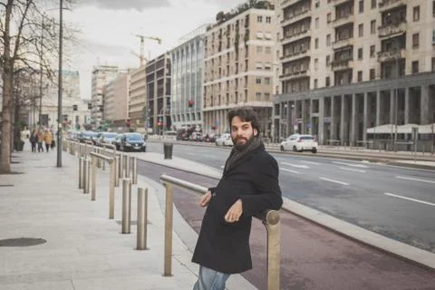 Young handsome bearded man posing in the city streets Stock Photos