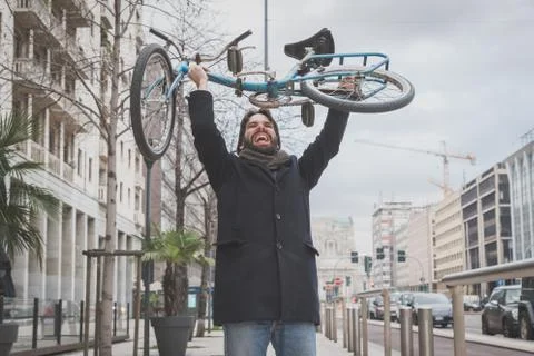 Young handsome bearded man posing with his bicyle Stock Photos
