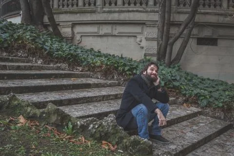 Young handsome bearded man posing in the city streets Stock Photos