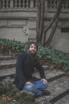 Young handsome bearded man posing in the city streets Stock Photos