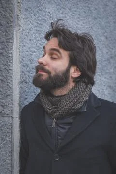 Young handsome bearded man posing in the city streets Stock Photos
