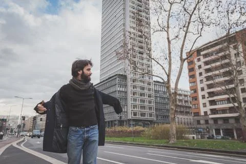 Young handsome bearded man posing in the city streets Stock Photos