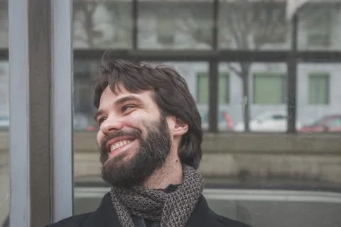 Young handsome bearded man posing in the city streets Stock Photos