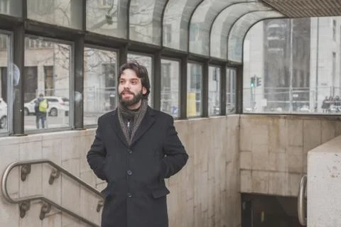 Young handsome bearded man posing in the city streets Stock Photos