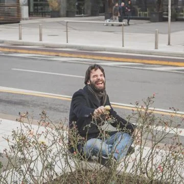 Young handsome bearded man posing in the city streets Stock Photos