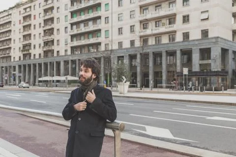 Young handsome bearded man posing in the city streets Stock Photos
