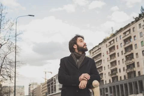 Young handsome bearded man posing in the city streets Stock Photos