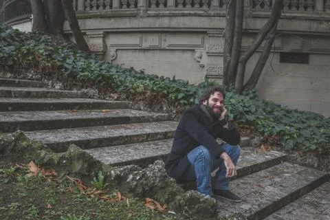 Young handsome bearded man posing in the city streets Stock Photos