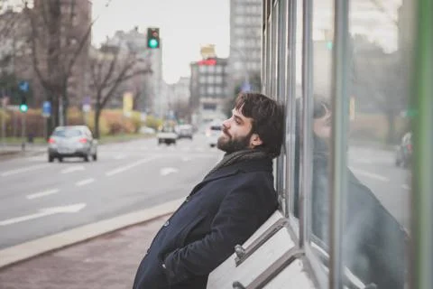 Young handsome bearded man posing in the city streets Stock Photos