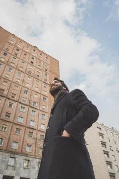 Young handsome bearded man posing in the city streets Stock Photos