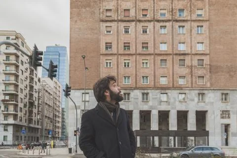 Young handsome bearded man posing in the city streets Stock Photos