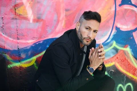 A young handsome bearded man posing in an urban background Stock Photos