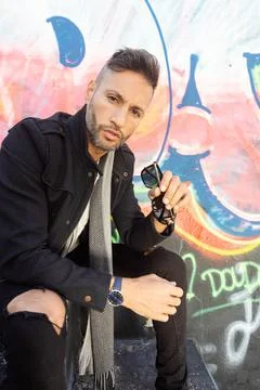 A young handsome bearded man posing in an urban background Stock Photos