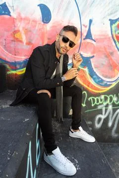 A young handsome bearded man posing in an urban background Stock Photos