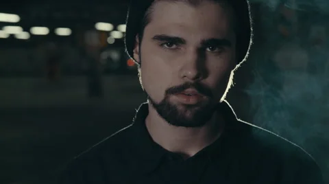 Young handsome bearded man smoking cigarette 库存影片 56269072