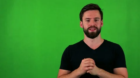 Young handsome bearded man talks to camera - green screen - studio Stock Footage 67477018