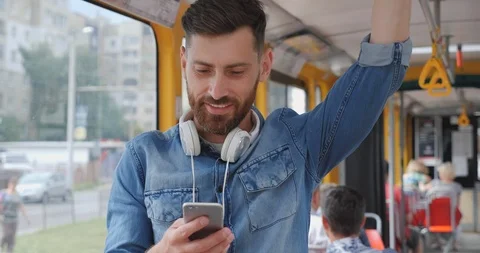 Young Handsome Bearded Man Using public Transport, Looking Happy and Pleasant Stock Footage 122995336