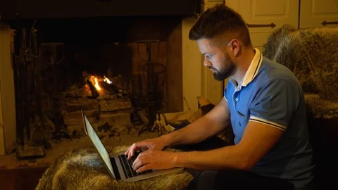 Young handsome bearded man is working on a laptop Stock Footage 107728828