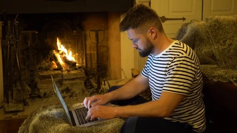 Young handsome bearded man is working on a laptop Stock Footage 107729130