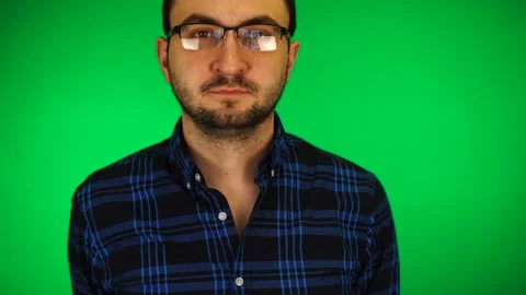 Young handsome bearded white man in glasses against green background Stock Footage 170726308