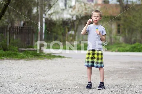 Young handsome blond schoolboy in casual clothing with funny serious expressi Stock Photos