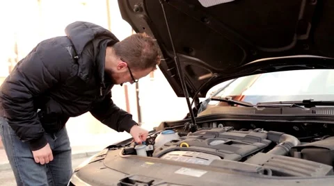 Young handsome boy in black jacket and glasses, standing behind his car 8 Stock Footage 49338340