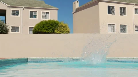 Young Handsome Boy Running and Jumping to the Swimming pool - Child diving to Stock Footage 148246143