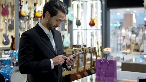 Young handsome business using and paying with smartphone contactless Stock Footage 120436077
