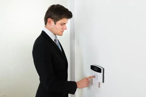 Young Handsome Businessman Entering Code In Security System Stock Photos