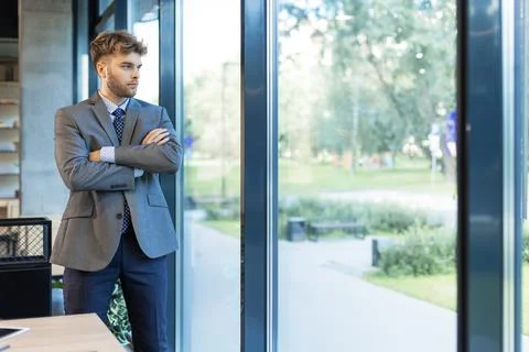 Young handsome businessman smiling in an office environment Stock Photos
