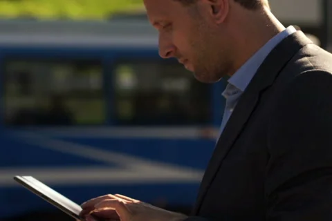 Young, handsome businessman with tablet computer in the city NTSC Stock Footage 42128730