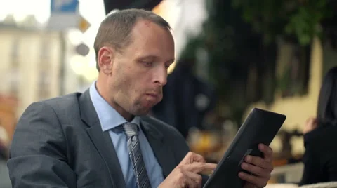 Young, handsome businessman with tablet computer in the cafe city HD Vídeo Stock 42128878