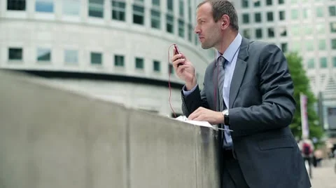 Young handsome businessman talking on mobile phone in the city HD Stock Footage 11497953
