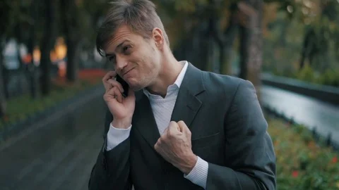 Young handsome businessman talking on mobile phone in the city. Guy heard good Stock Footage